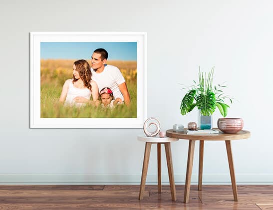 A large-format print displayed on a wall above a side table